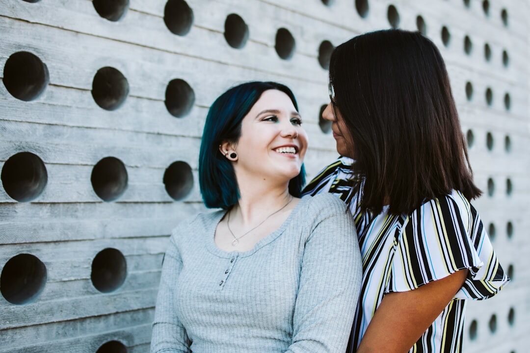 Adult daughter and her older mother talking and smiling together